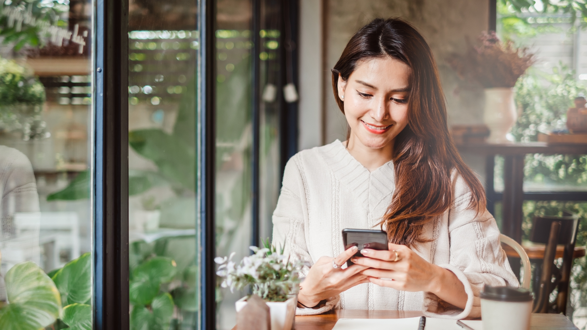 Woman checking her personal account on the Thread Personal Banking app on her phone.